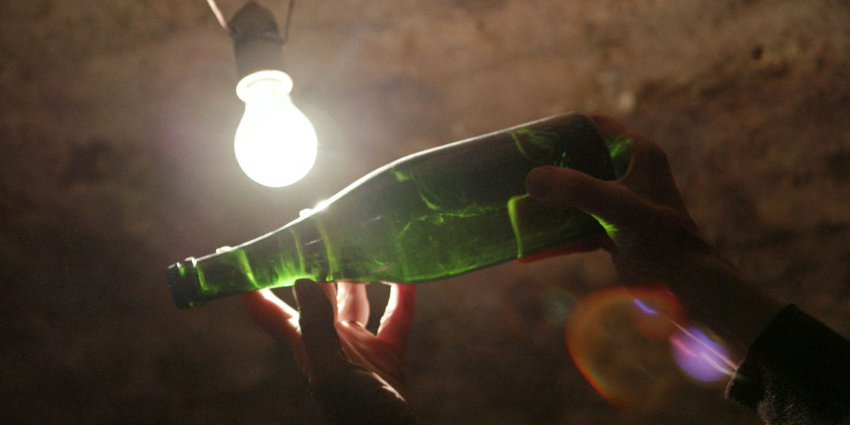 A bottle held up to the light in A Year in Champagne wine movie.