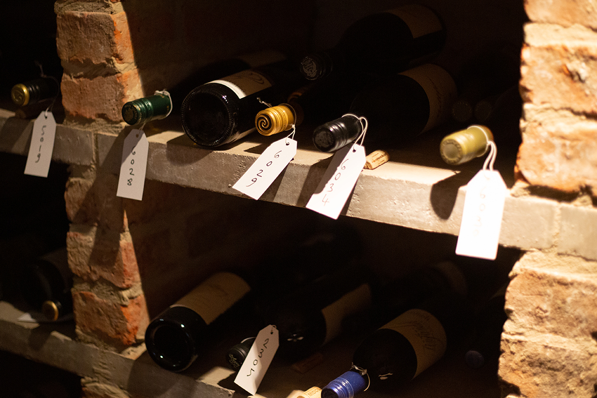 A wine cellar with labels on bottles.